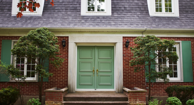 closeup of dutch colonial home with brick facade